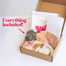Load image into Gallery viewer, Contents of the Chocolate Gingham woven tote bag kit: feather yarn, plastic canvas, straps and tools.