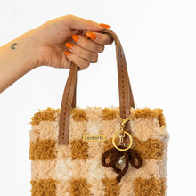 Load image into Gallery viewer, Bow keychain on the Chocolate Gingham woven tote bag.