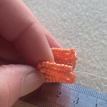 Load image into Gallery viewer, Close-up of a beaded daffodil showing yellow and orange seed bead petals.