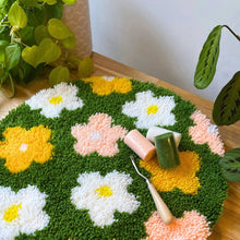 Load image into Gallery viewer, Contents of the Flower Bomb Green rug making kit with pre-backed rug base and yarn.