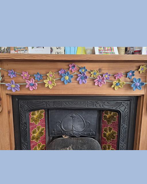 Finished flower garland crochet kit design in two sizes.