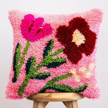 Load image into Gallery viewer, Finished Fuchsia Wild Blooms latch hook cushion with pink and burgundy flowers by Craft Club.
