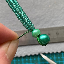 Load image into Gallery viewer, Close-up of an iridescent beaded dragonfly showing metallic teal glass beads.