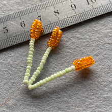 Load image into Gallery viewer, Close-up of a beaded lily showing orange seed bead detail.