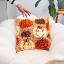Load image into Gallery viewer, Pumpkin Spice latch hook cushion styled on a sofa.