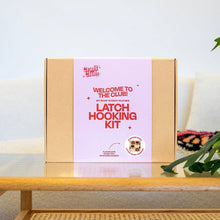 Load image into Gallery viewer, Contents of the Pumpkin Spice latch hook cushion kit: pre-sewn cushion canvas, yarn and latch hook.