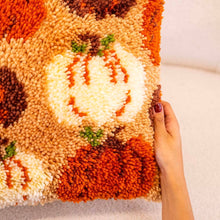 Load image into Gallery viewer, Close-up of fluffy latch hook yarn pumpkins on the Pumpkin Spice cushion.