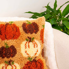 Load image into Gallery viewer, Close-up of fluffy latch hook yarn pumpkins on the Pumpkin Spice cushion.