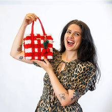 Load image into Gallery viewer, Red Gingham woven tote bag being carried as a handbag.