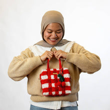 Load image into Gallery viewer, Red Gingham woven tote bag being carried as a handbag.