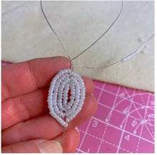 Load image into Gallery viewer, Close-up of a beaded snowdrop flower showing white seed bead petals.