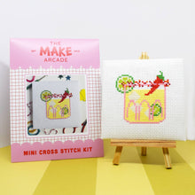 Load image into Gallery viewer, Make Arcade mini cross stitch kit envelope beside a finished spicy margarita cross stitch on a mini easel
