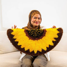 Load image into Gallery viewer, Sunflower mirror rug being made with a wooden latch hook.