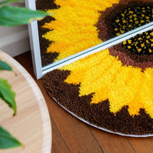 Load image into Gallery viewer, Sunflower latch hook rug under a mirror, creating a full flower reflection.
