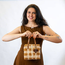 Load image into Gallery viewer, Chocolate Gingham woven tote bag being carried as a handbag.
