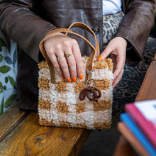 Load image into Gallery viewer, Chocolate Gingham woven tote bag being carried as a handbag.
