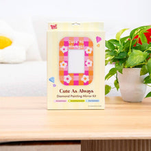Load image into Gallery viewer, Cute As Always diamond painting mirror frame kit box on a wooden table next to a plant
