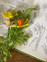Load image into Gallery viewer, Close-up of a beaded daffodil showing yellow and orange seed bead petals.
