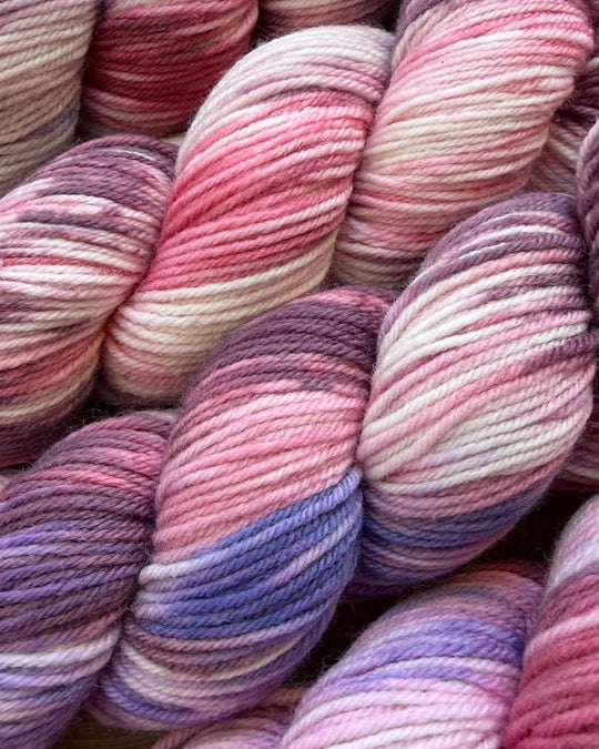 Faded DK Yarn skeins in pink, purple and cream by Solicious Yarns