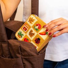 Load image into Gallery viewer, Fall Harvest Charms needlepoint pouch holding everyday essentials.
