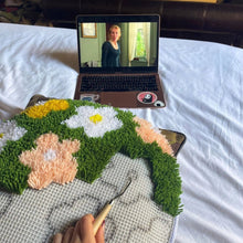 Load image into Gallery viewer, Flower Bomb Green latch hook rug being made with a latch hook tool.
