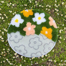 Load image into Gallery viewer, Flower Bomb Green latch hook rug being made with a latch hook tool.
