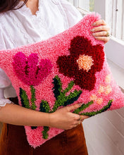 Load image into Gallery viewer, Close-up of fuchsia latch hook yarn flowers showing the soft pile texture.
