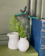 Load image into Gallery viewer, Iridescent beaded dragonflies displayed as home décor.
