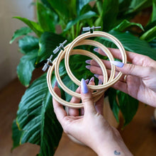 Load image into Gallery viewer, Contents of the Kitten Minis cross stitch kit: three hoops, cream Aida and 15 skeins of thread.
