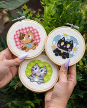 Load image into Gallery viewer, Three finished kitten mini cross stitches in wooden hoops by Craft Club.
