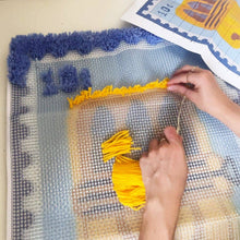 Load image into Gallery viewer, Sardine Stamp rug being made with a latch hook tool.

