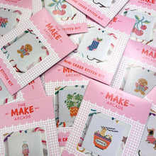 Load image into Gallery viewer, The Make Arcade mini cross stitch kits in pink envelopes, including Sardines, laid out together
