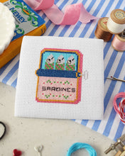 Load image into Gallery viewer, Sardines mini cross stitch kit by The Make Arcade, a finished stitched sardine tin on white Aida fabric
