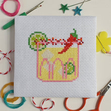 Load image into Gallery viewer, Close-up of a finished spicy margarita cross stitch with lime slices and a red chilli
