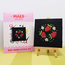 Load image into Gallery viewer, Strawberry patch mini cross stitch kit in its pink Make Arcade envelope next to the finished stitching on a mini easel
