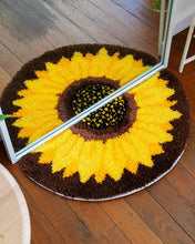 Load image into Gallery viewer, Sunflower latch hook rug under a mirror, creating a full flower reflection.
