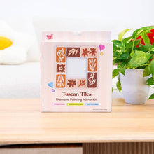 Load image into Gallery viewer, Tuscan Tiles diamond painting mirror frame kit box on a wooden table next to a plant
